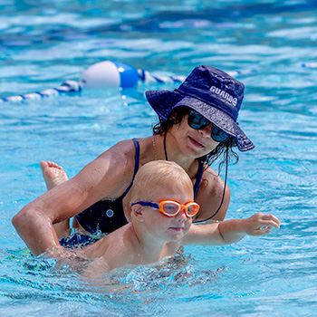 swim teacher and toddler in pool