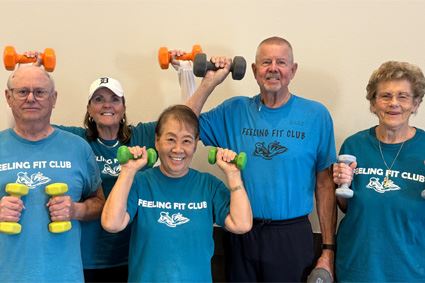 Feeling Fit Class Participants holding weights and smiling