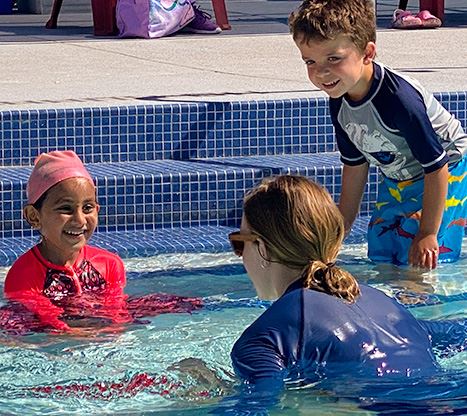 kids and instructor in pool